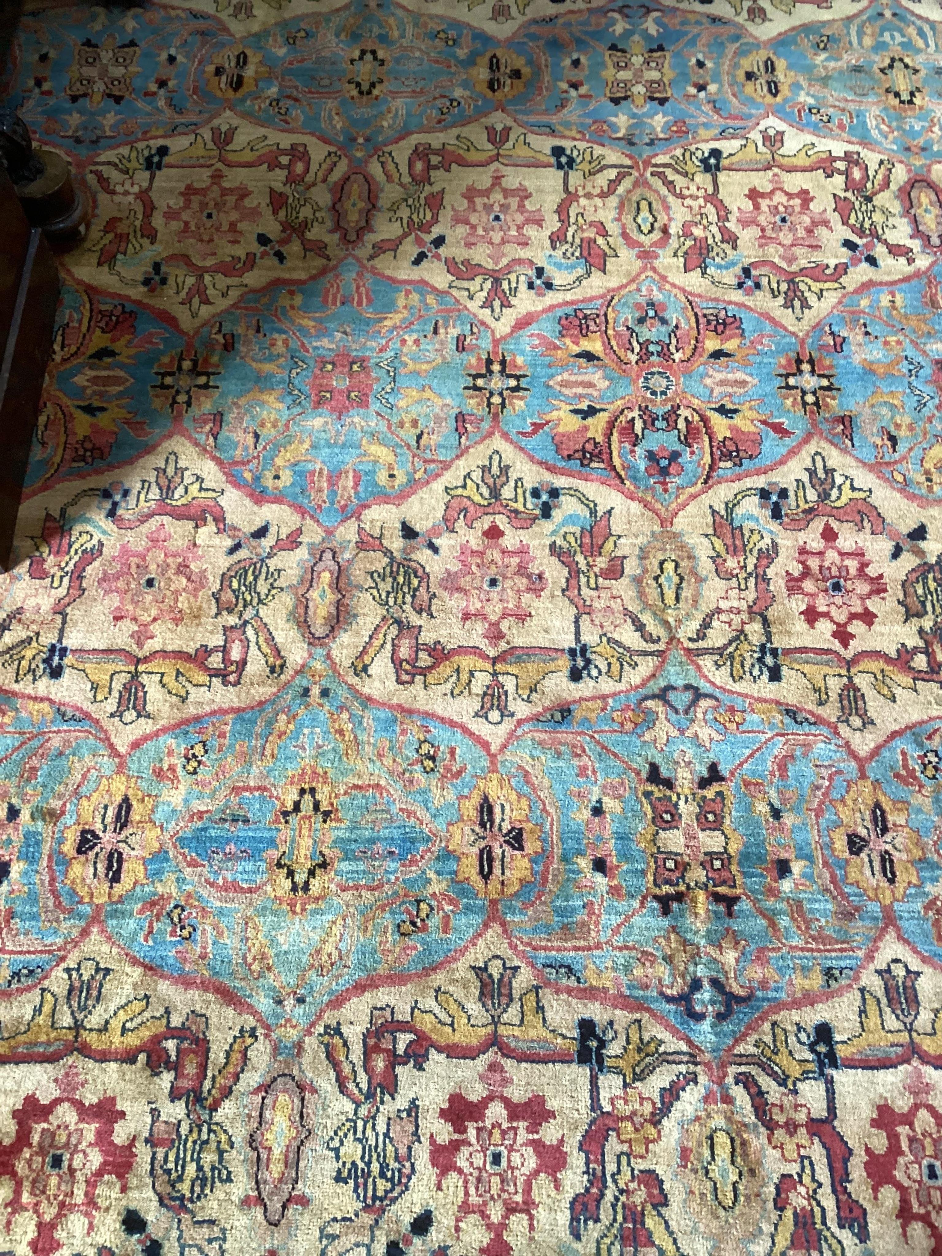 A large Persian design ivory ground carpet, 590 x 365cm. Condition - good